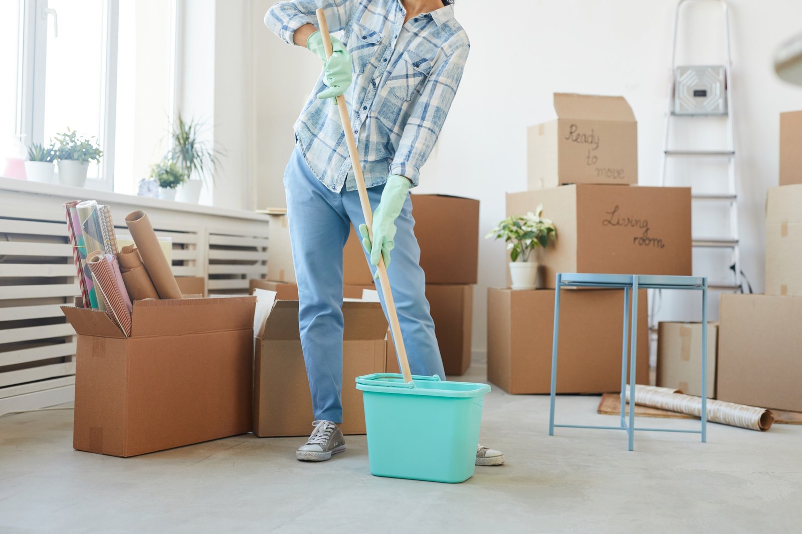Young Woman Washing Floors in New House